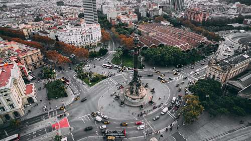 aerial view bird's eye view of white and brown concrete high-rise building intersection